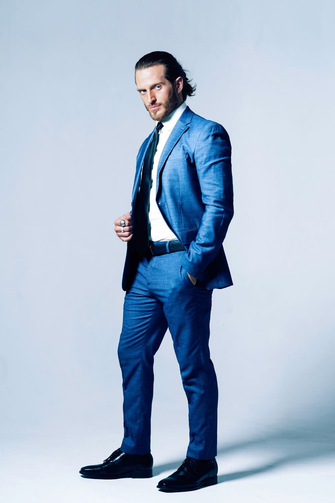 Russell Snipes. Full-length commercial look in a blue suit on a white backdrop