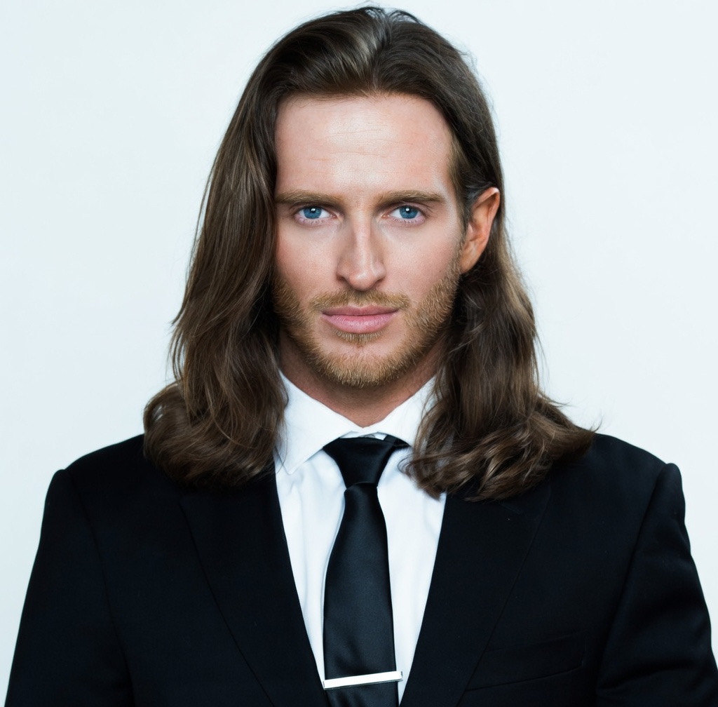 Russell Snipes. Formal headshot in black suit and tie