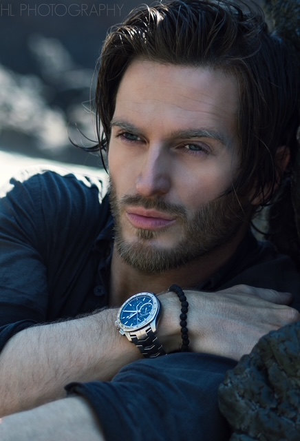 Russell Snipes. Close-up with hand on chin, wearing a wristwatch