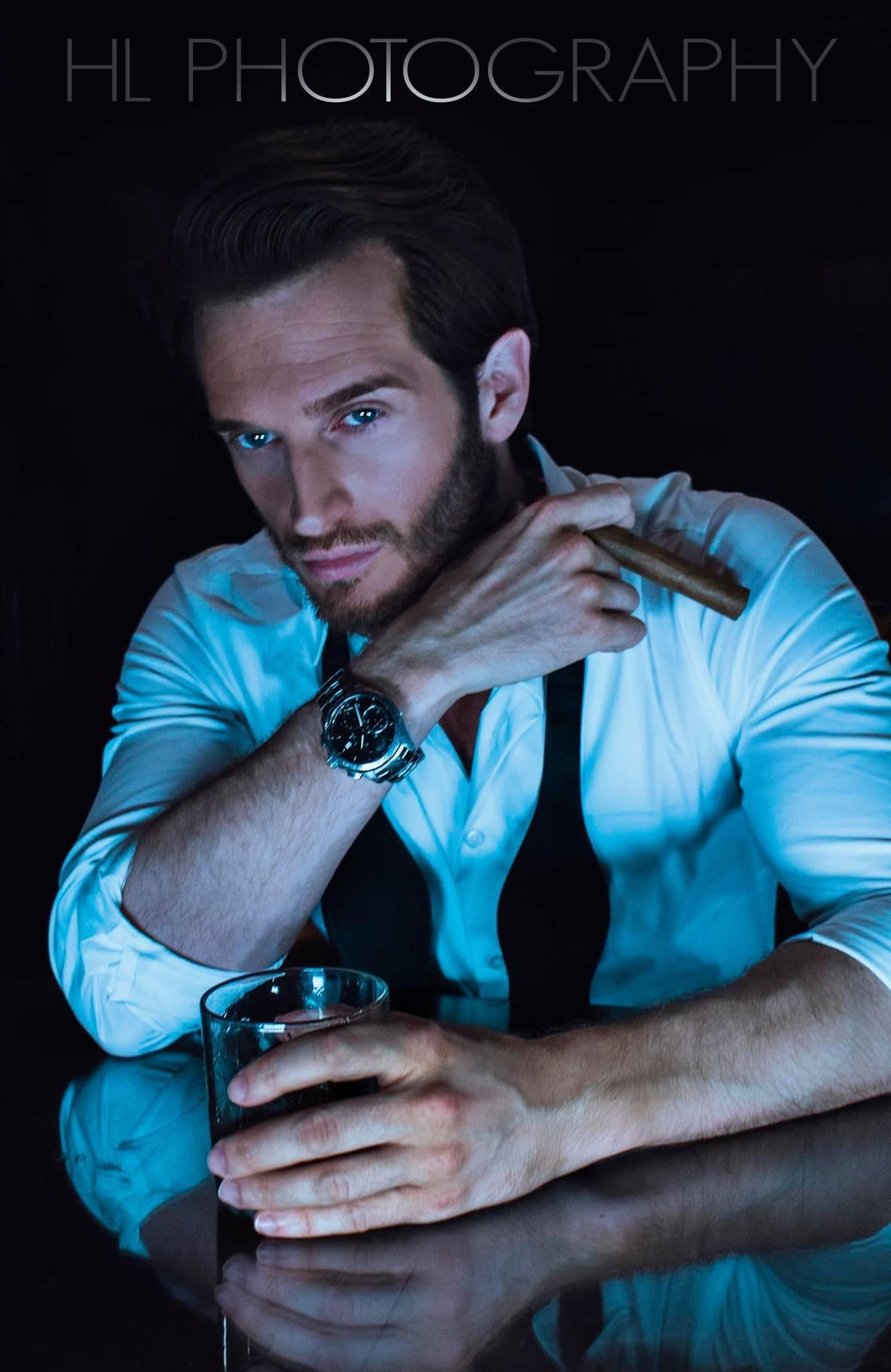 Russell Snipes. Seated portrait in shirt and tie, blue tones