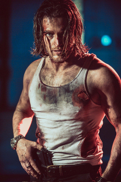Russell Snipes. Action still in a bloodied white tank top