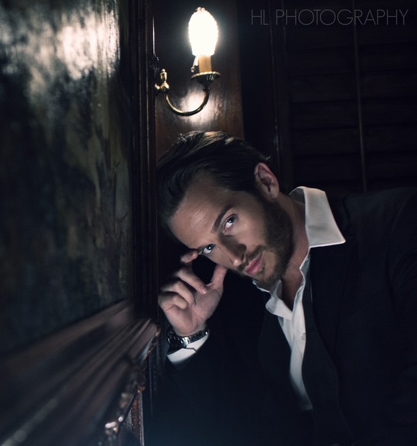 Russell Snipes. Moody portrait in a dark doorway
