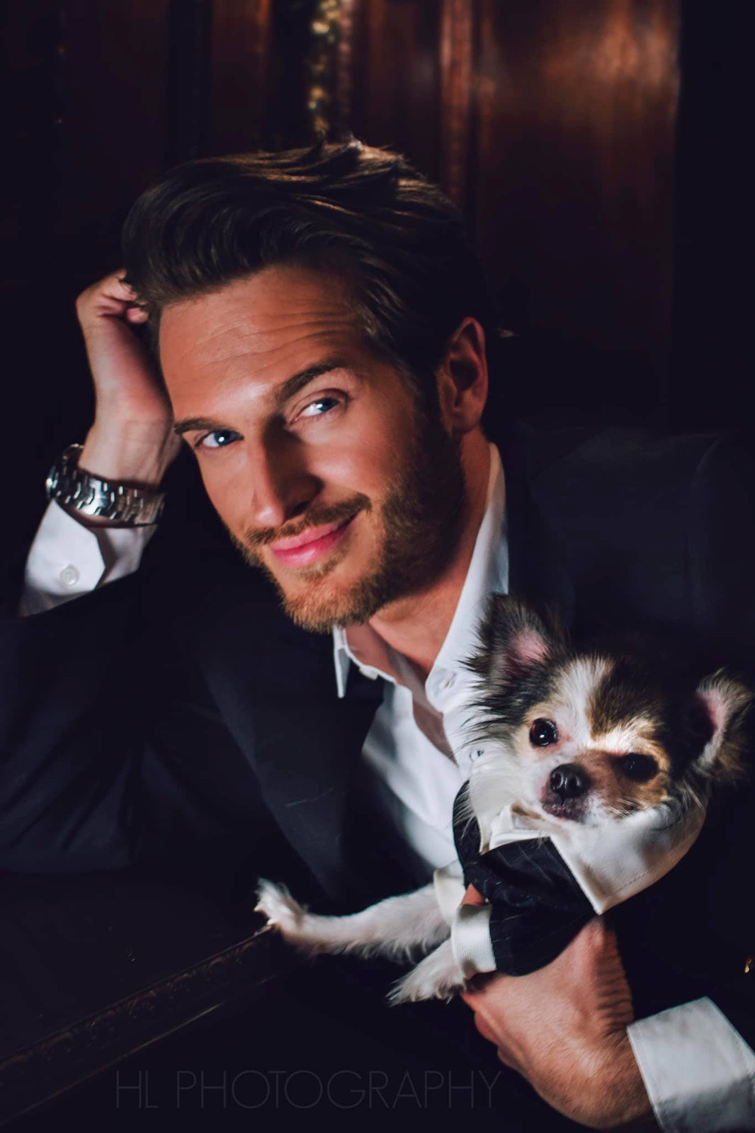 Russell Snipes. Portrait in a suit holding a small dog