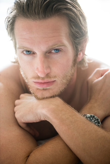 Russell Snipes. Close-up with arms folded, bare-shouldered